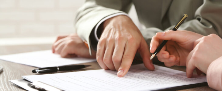 man pointing at document