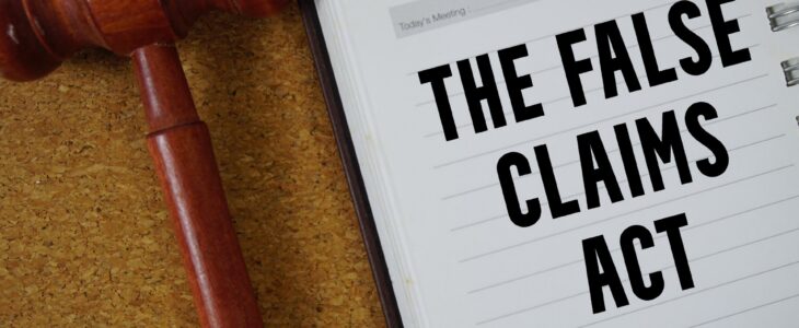 A notebook that says The False Claims Act next to a gavel