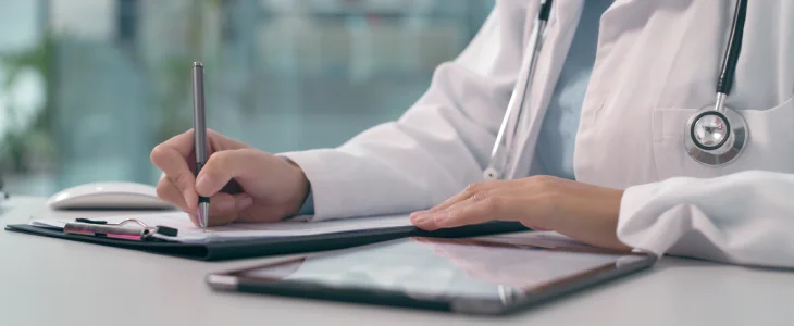 Healthcare worker completing documents